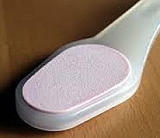 A sanding block designed to file dead skin off your heels. You can also use pumice.
